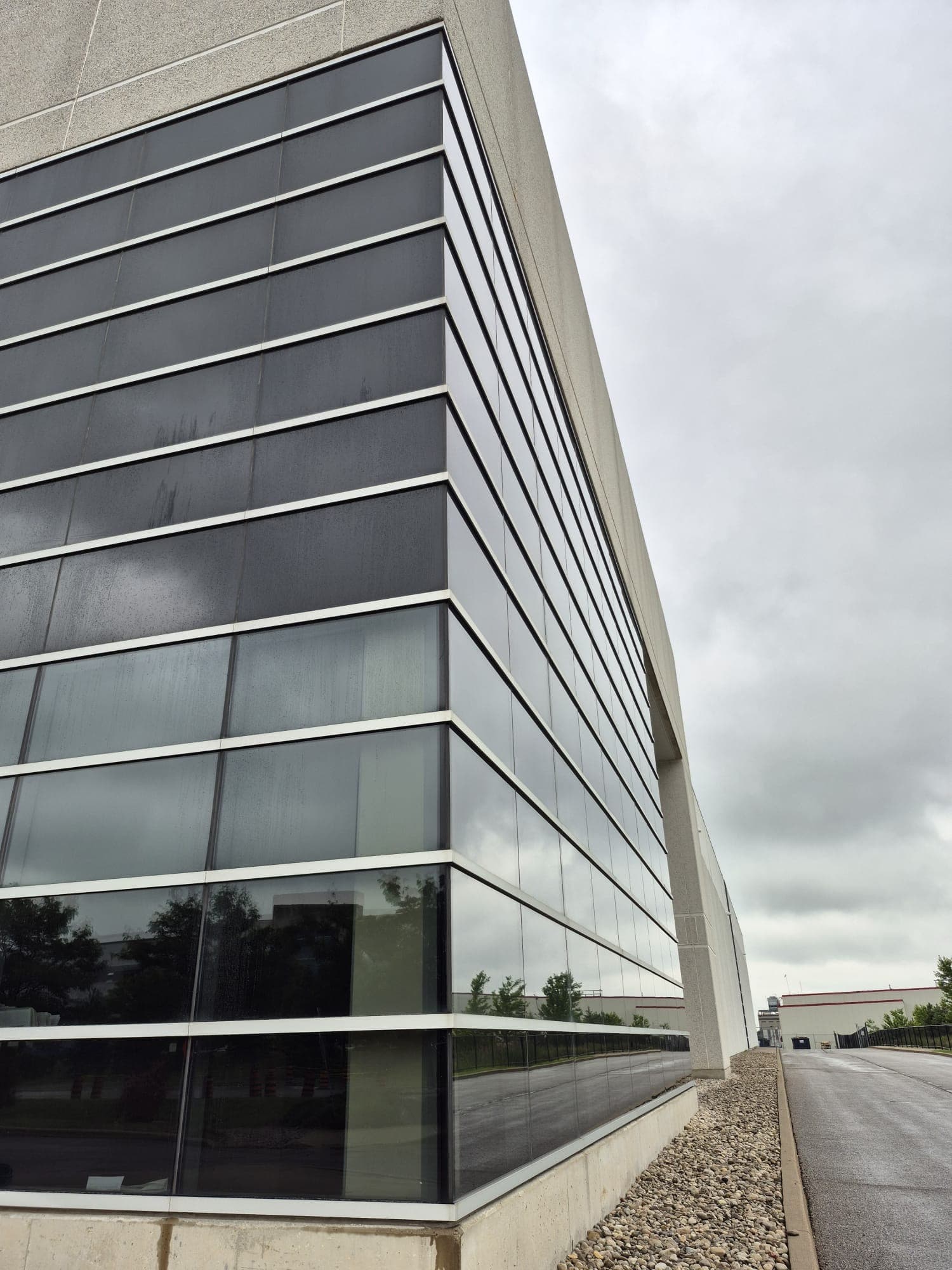 Corner view of a large cleaned commercial glass building